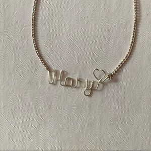 “Mary” necklace.